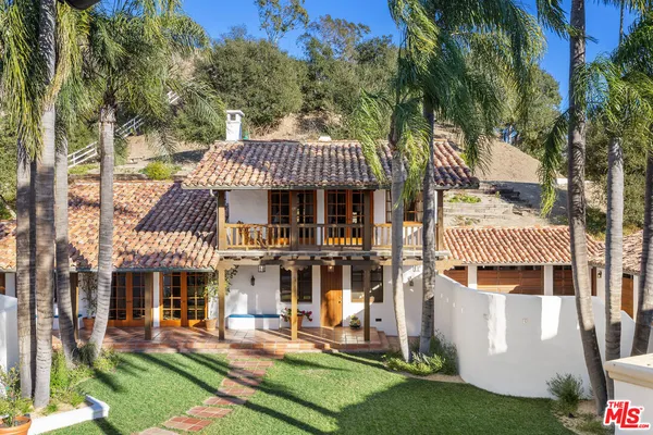 a bedroom with furniture and a fireplace