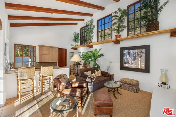 a living room with a sink and furniture