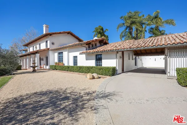 a front view of a house with a yard and a garage