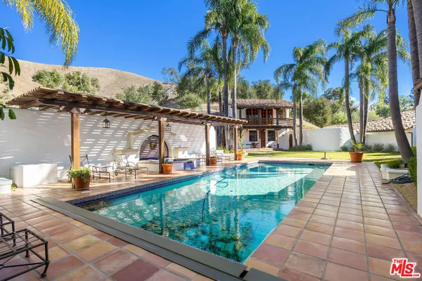 a view of swimming pool with a patio