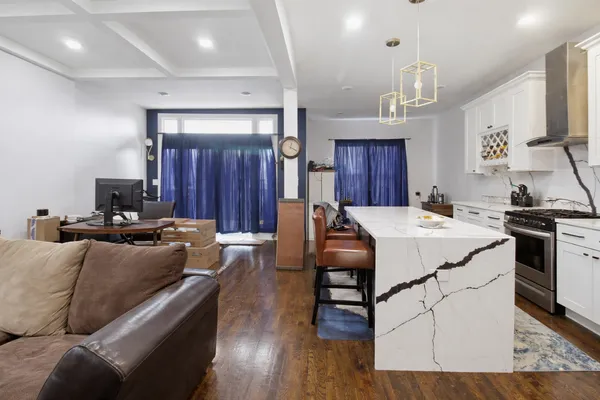 a living room with furniture a wooden floor and a sink