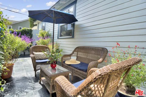 a outdoor living space with furniture and umbrella