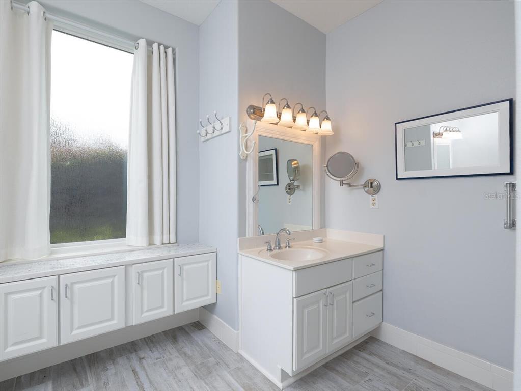 6635 Southwest 113th Place Ocala, FL 34476 - Photo 17 of 43 a bathroom with a sink vanity and mirror