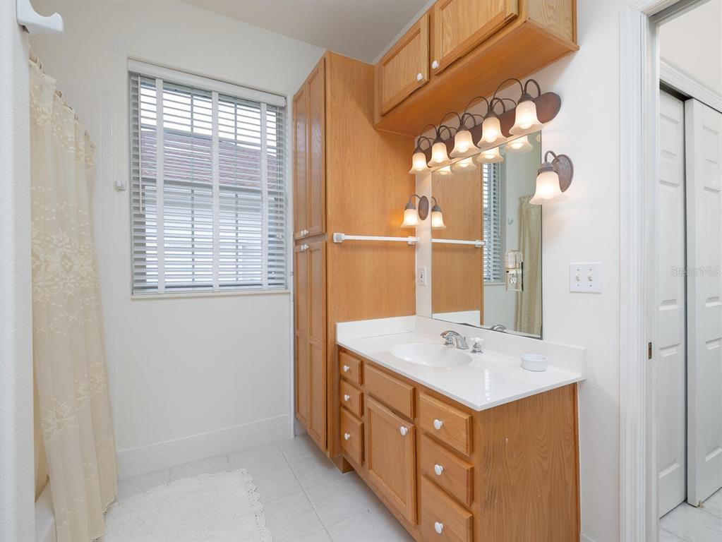 6635 Southwest 113th Place Ocala, FL 34476 - Photo 24 of 43 a bathroom with a sink vanity and a mirror