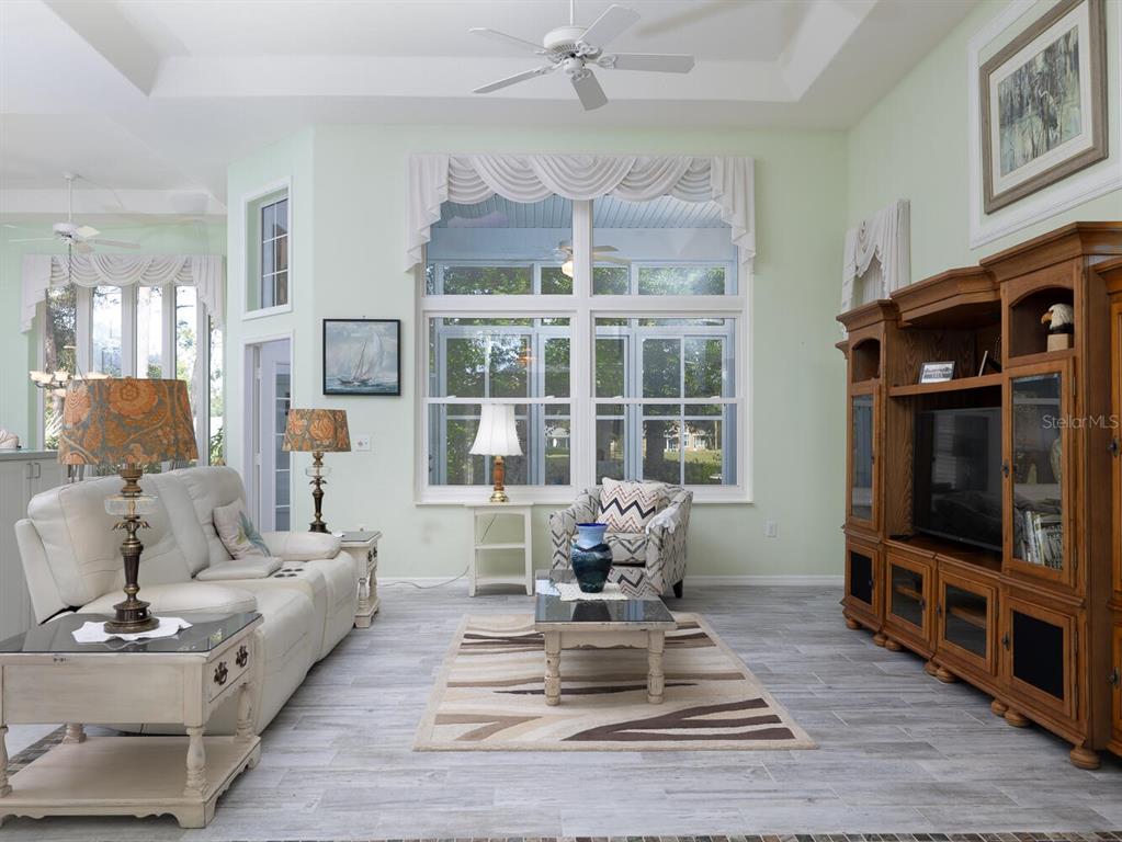 6635 Southwest 113th Place Ocala, FL 34476 - Photo 6 of 43 a living room with furniture a flat screen tv and a fireplace