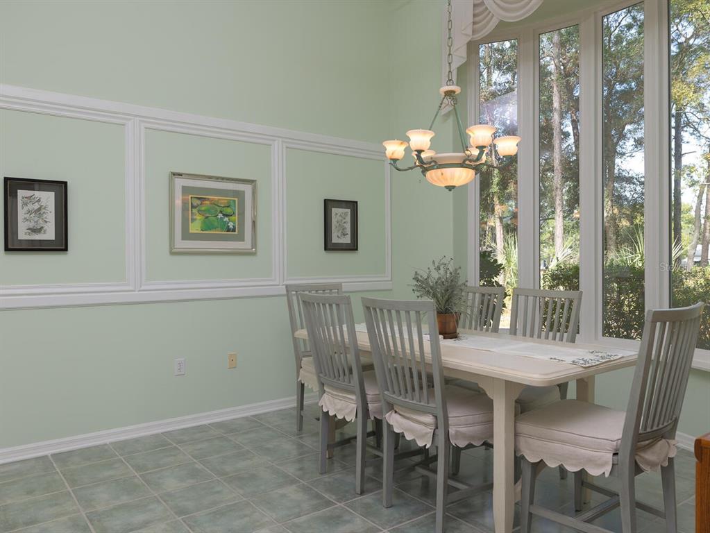6635 Southwest 113th Place Ocala, FL 34476 - Photo 8 of 43 a view of a dining room with furniture and a chandelier