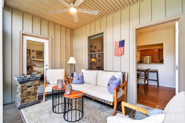 a living room with patio furniture and a wooden floor