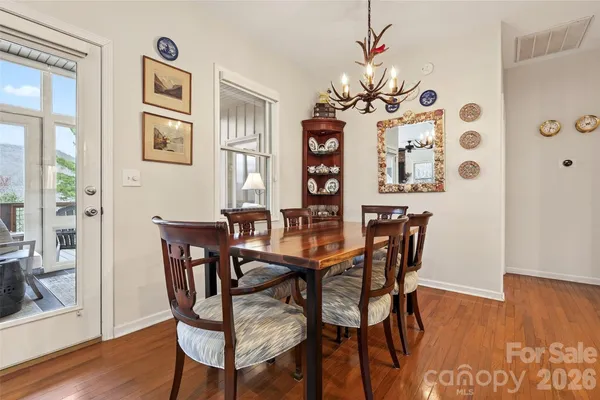 a view of a dining room with furniture wooden floor and chandelier