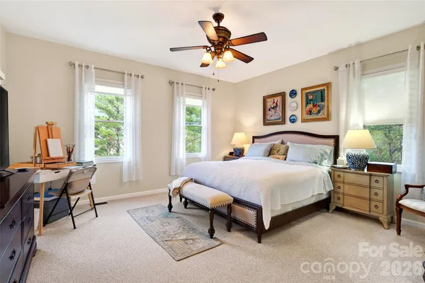 a bedroom with a bed table and window