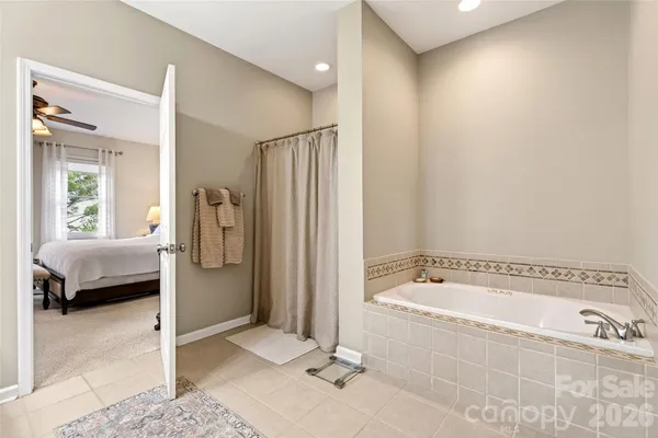 a spacious bathroom with a tub and a shower