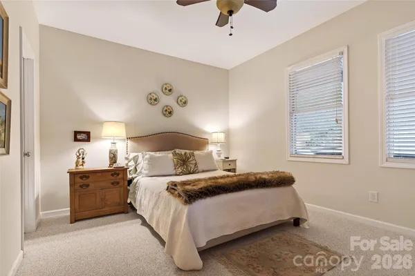 a bedroom with a bed lamps and window