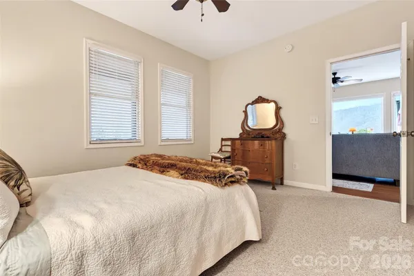 a bedroom with a bed mirror and window