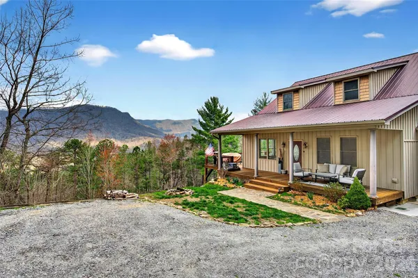 a front view of a house with a yard and outdoor seating