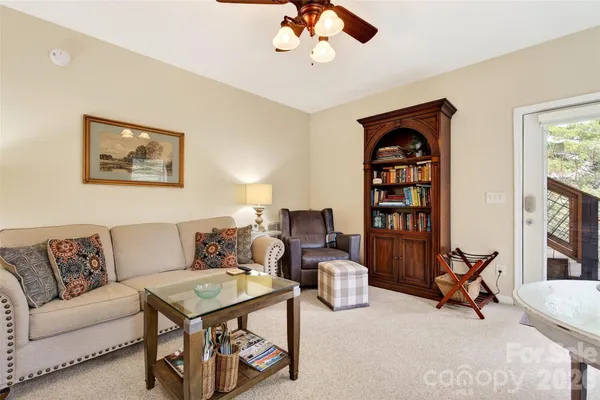 a living room with furniture a dining table and a bookshelf
