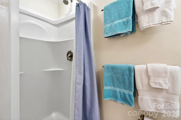 a bathroom with a shower and a sink