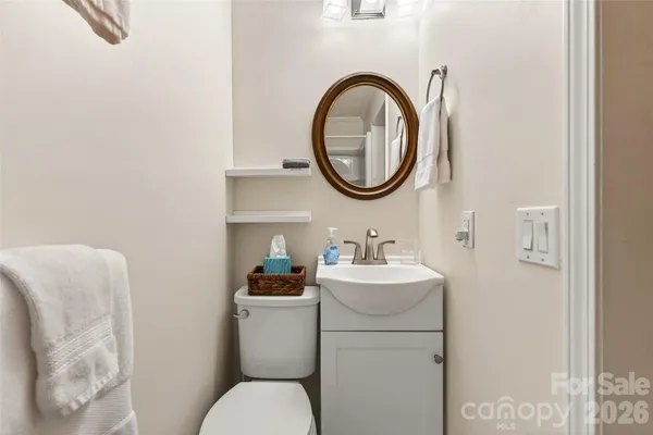 a bathroom with a toilet a sink and a mirror