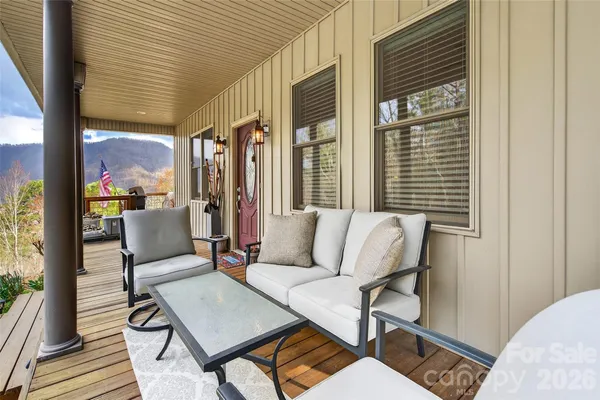 a balcony view with a couch and wooden floor
