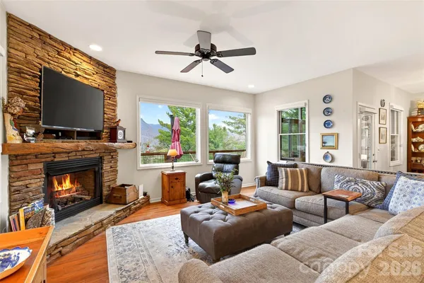 a living room with furniture a flat screen tv and a fireplace