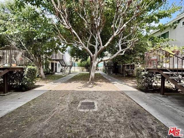 a view of a yard with cars