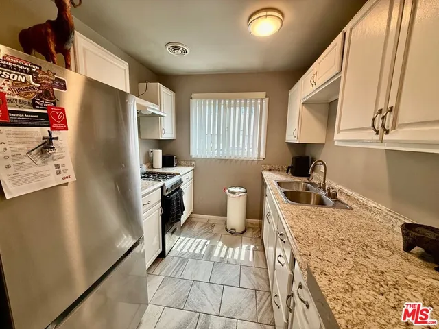 a kitchen with a refrigerator sink and stove