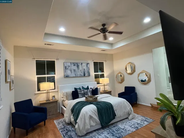 a spacious bedroom with a bed and a couch