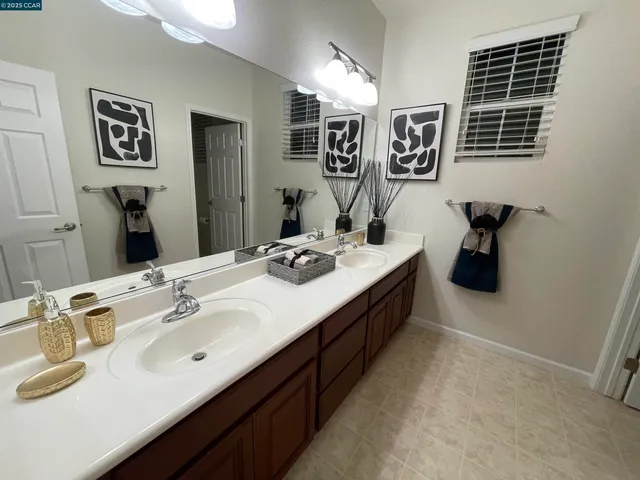a bathroom with a double vanity sink and a mirror