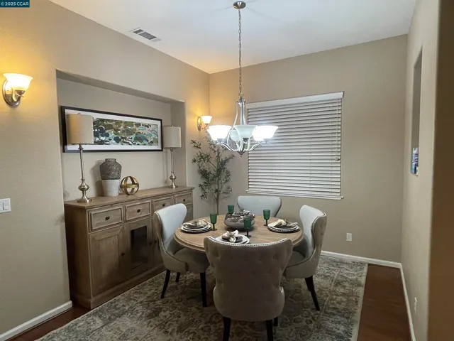 a view of a dining room with furniture window and wooden floor