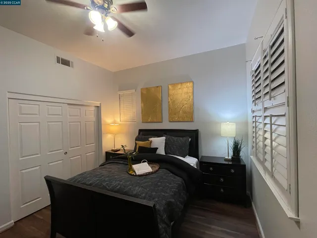 a bedroom with a bed and a chandelier