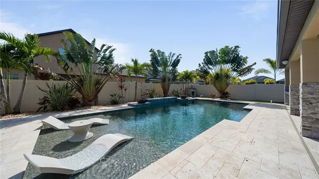 a view of swimming pool with outdoor seating and plants