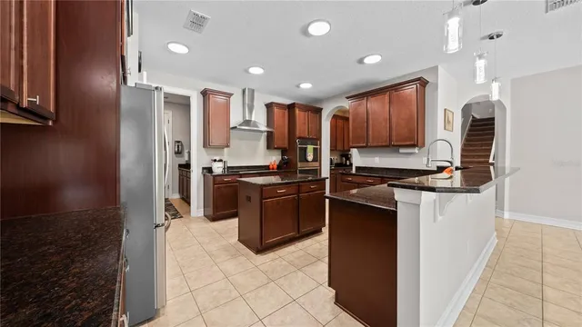 a kitchen with stainless steel appliances granite countertop a stove a microwave and cabinets
