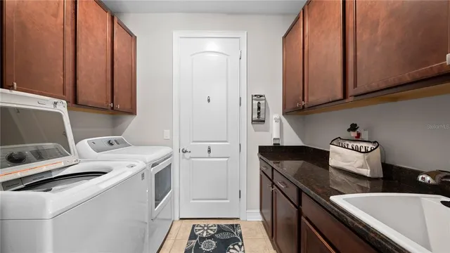 a large bathroom with a double vanity sink a mirror and a shower