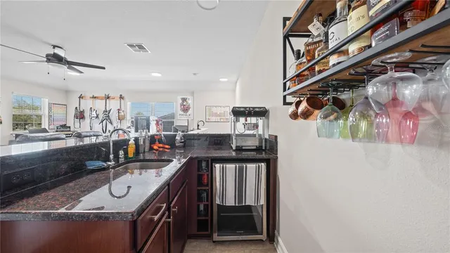 a view of a house with backyard and sitting area