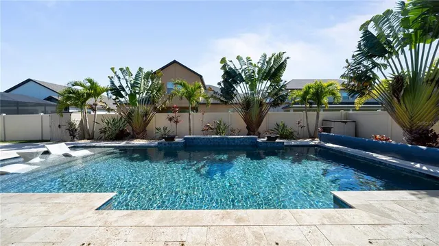 an aerial view of a house with a swimming pool outdoor seating and mountain view