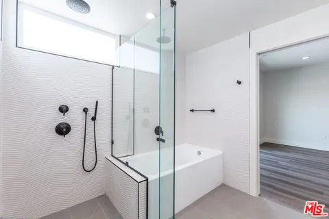 a bathroom with a bath tub and shower