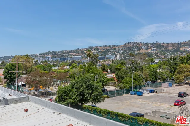 an aerial view of a house with a yard and street view