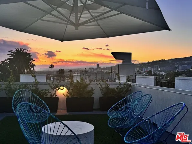 a view of balcony with furniture and a potted plant