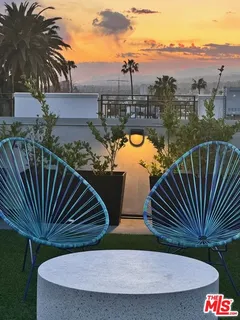 a view of a swimming pool with a deck and a garden