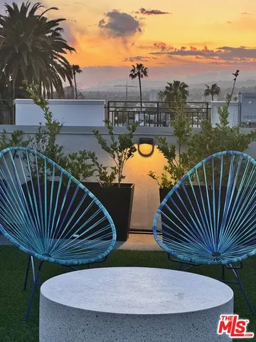 a view of a swimming pool with a deck and a garden
