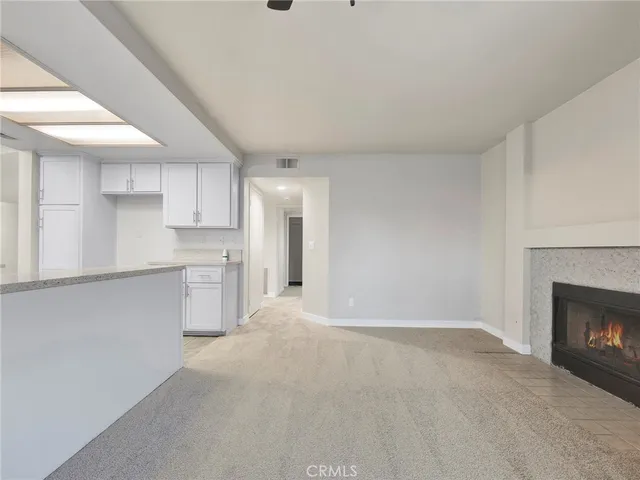 a view of a kitchen with a sink and a fireplace