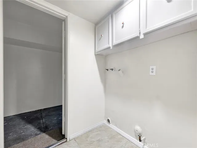 a view of storage and utility room with cabinets