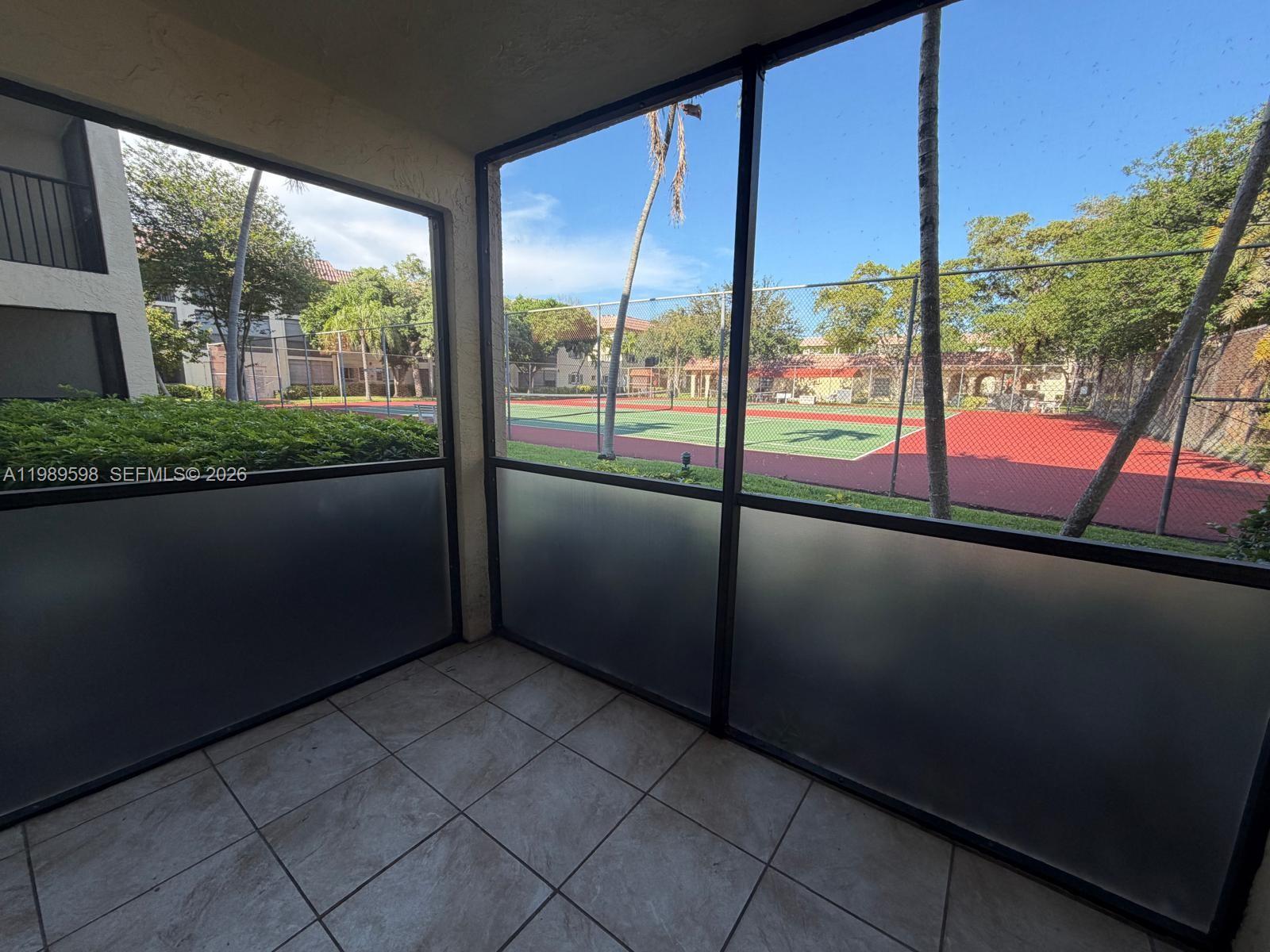 253 South Cypress Road, Unit 214 Pompano Beach, FL 33060 - Photo 3 of 25 a view of an empty room with a floor to ceiling window