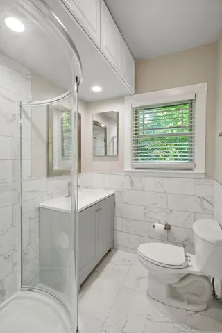 a bathroom with a toilet sink and mirror