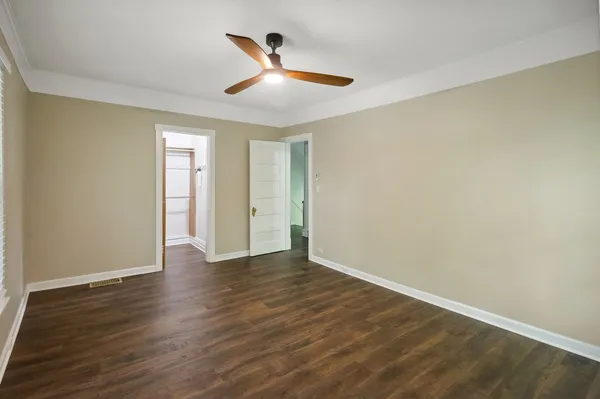 a view of an empty room with wooden floor