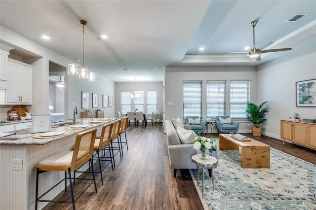 a very nice looking living room with a large window and wooden floors