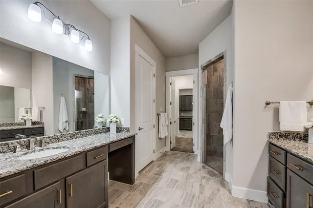 a spacious bathroom with a granite countertop sink mirror and a toilet