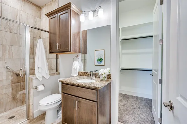 a bathroom with a sink toilet and shower