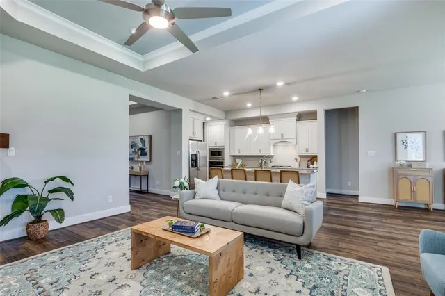 a living room with furniture and wooden floor