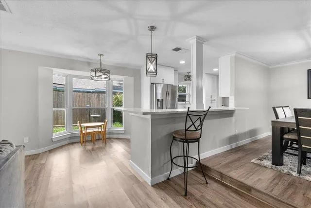 a kitchen with stainless steel appliances granite countertop a stove and a refrigerator