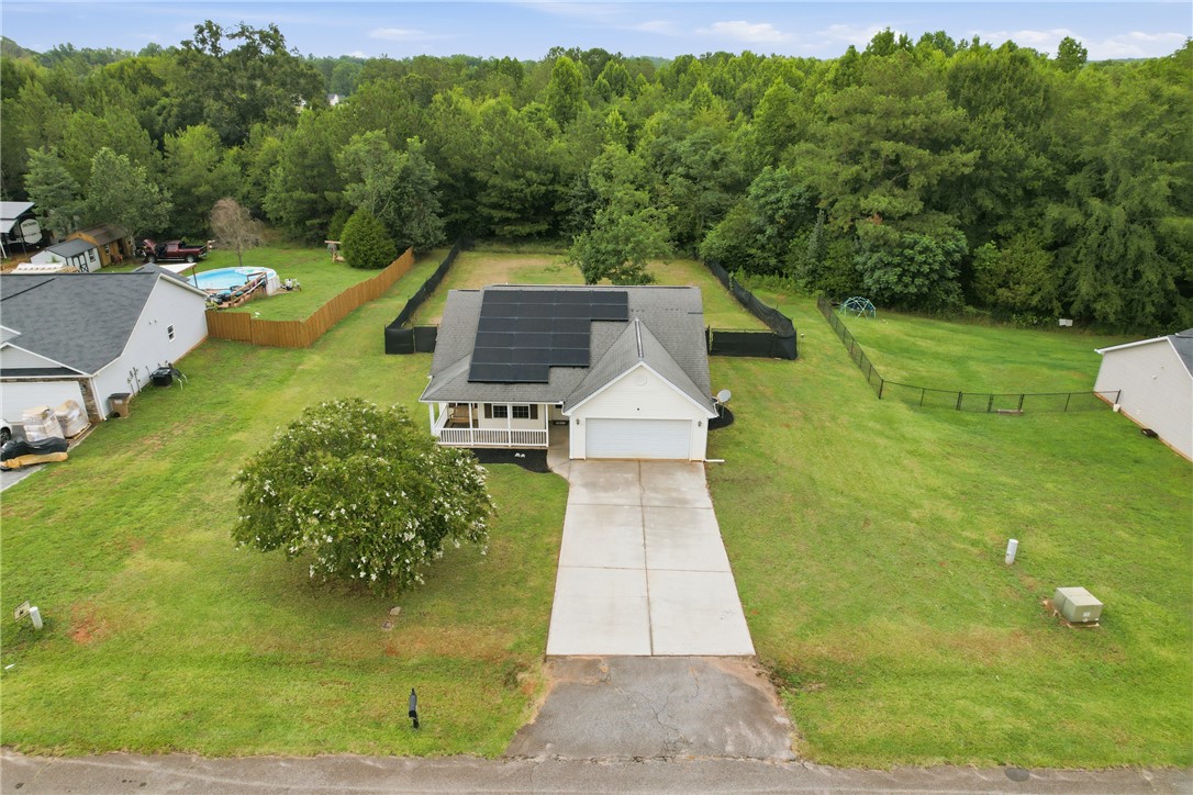105 Lacy Lane Anderson, SC 29621 - Photo 14 of 16 A charming single-story residence boasts solar panels, an attached garage, and a welcoming front porch, set on a verdant lot.