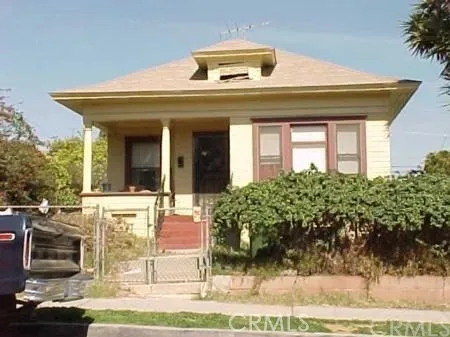 a view of a white house with large windows